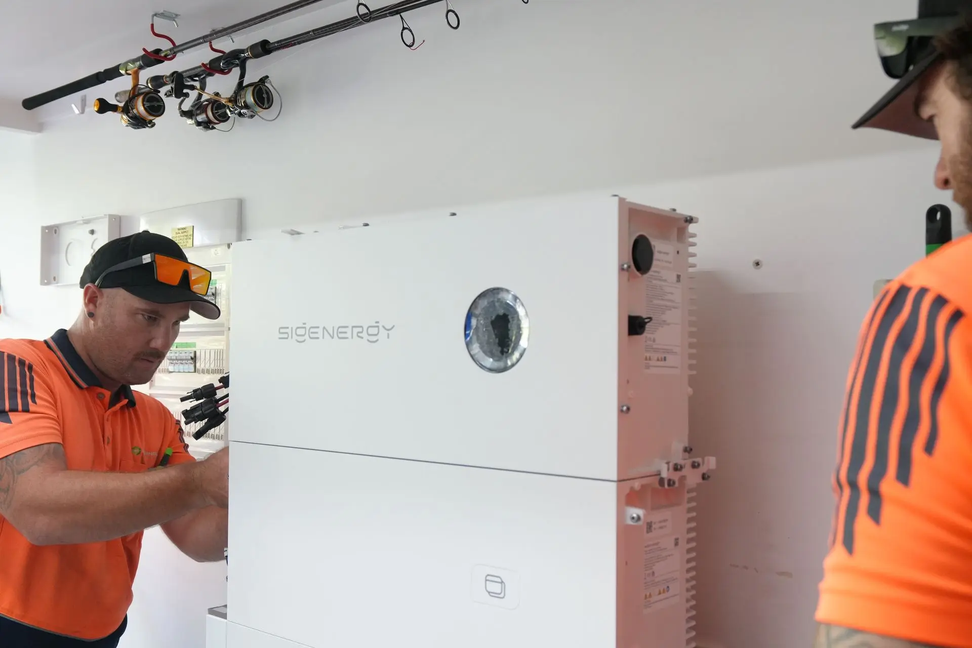 Springers Solar electricians installing an inverter
