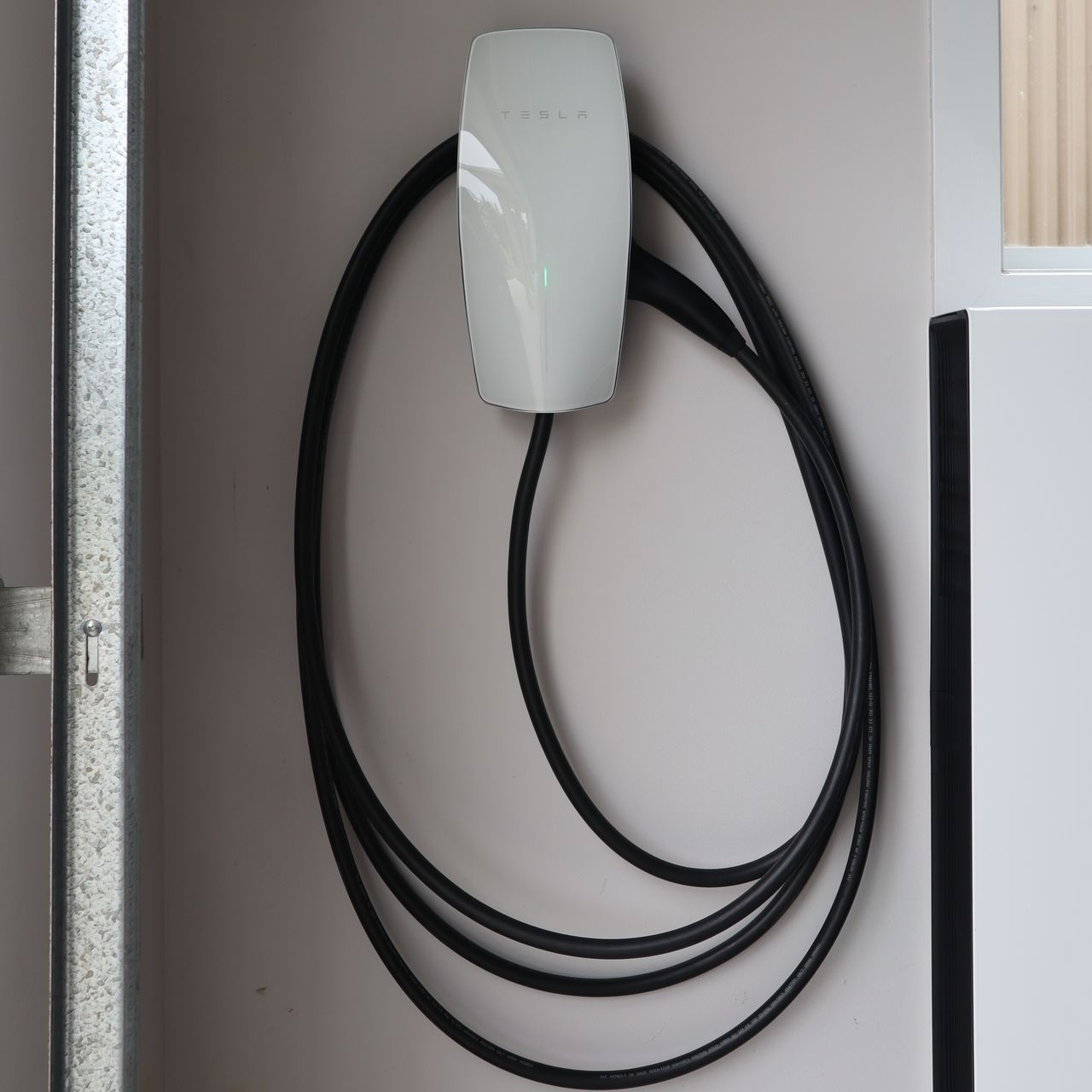 A Tesla Wall Connector installed at a home A Tesla Wall Connector installed at a home