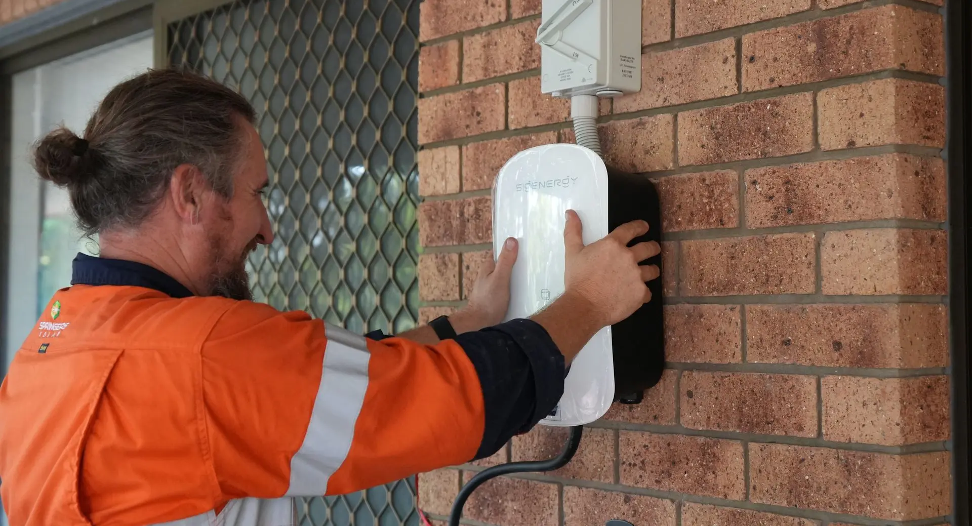 A Springers Solar electrician installing an EV charger