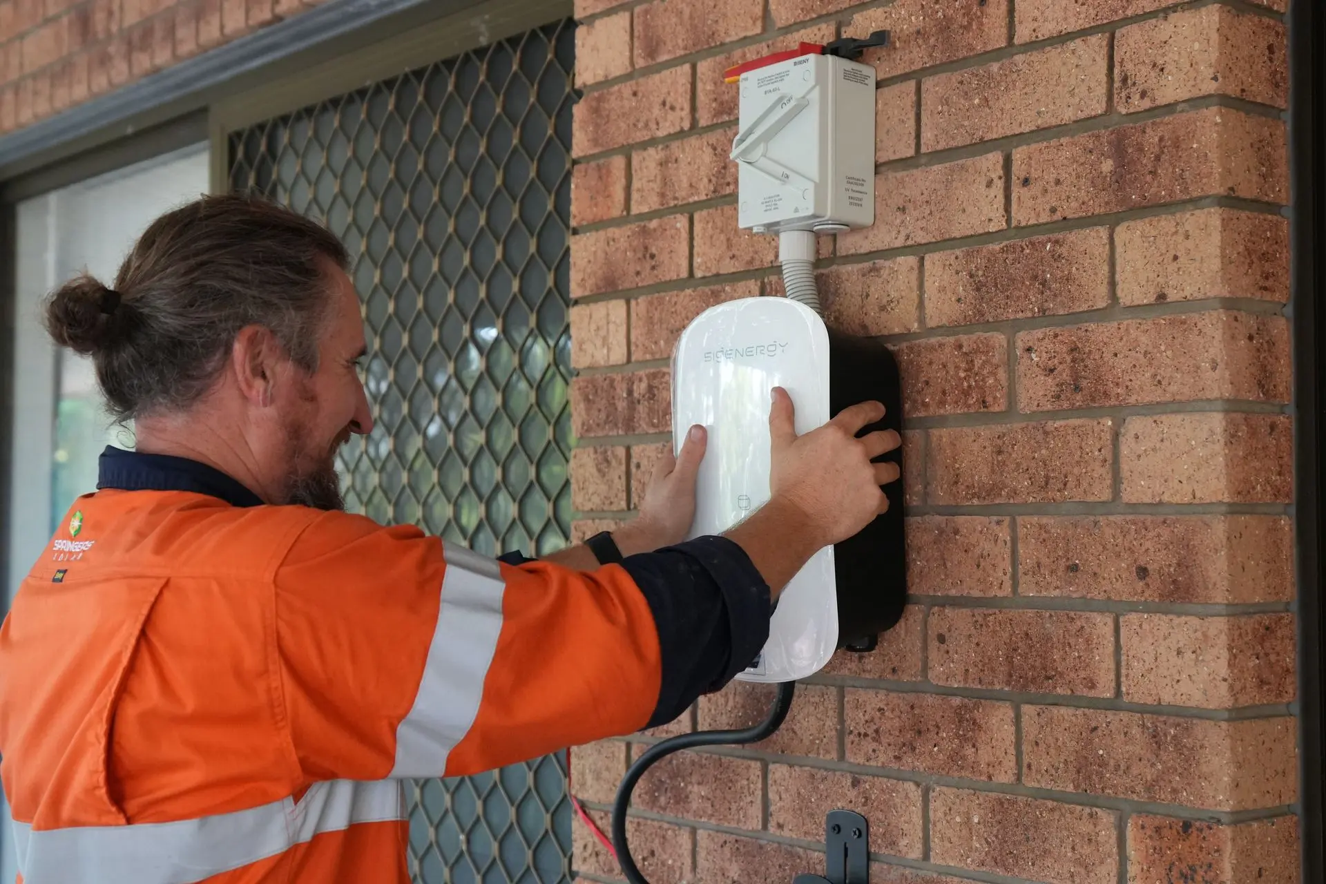 A Springers Solar electrician installing an EV charger